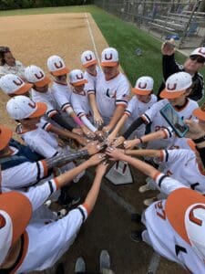 Baseball U Long Island players putting hands in before a game